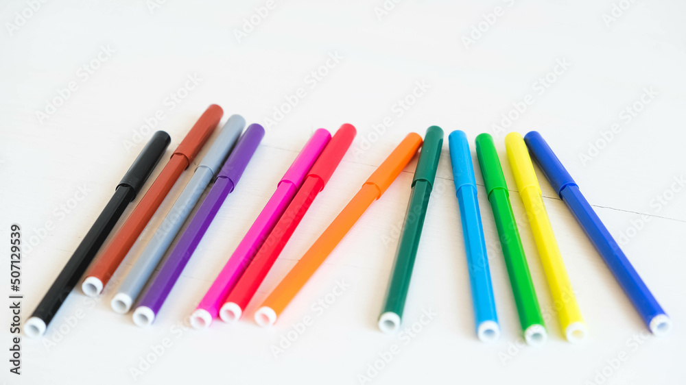 Multicolored felt-tip pens on a white background Multicolored felt-tip pens on a white background
