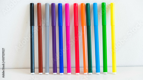 Multicolored felt-tip pens on a white background
