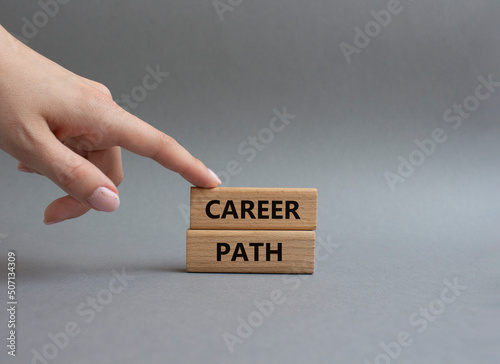 Career path symbol. Concept word Career path on wooden blocks. Beautiful grey background. Businessman hand. Business and Career path concept. Copy space