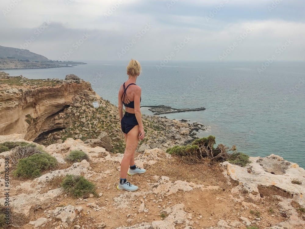 Beauty blonde woman resting after sports running in mountains. Rhodes Island, Grece