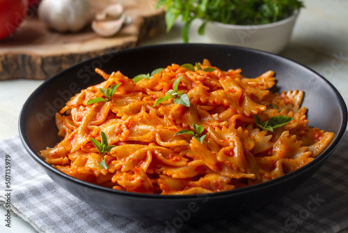 Farfalle pasta with tomato sauce, bow tie pasta tomatoes sauce (Turkish name; domatesli kelebek makarna) photo