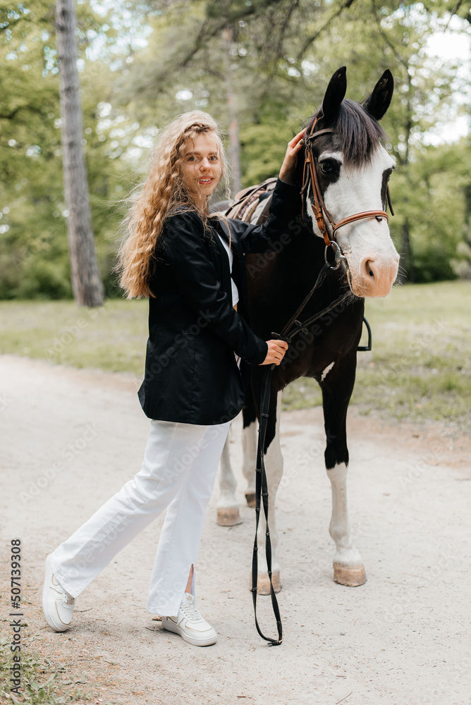 Obraz premium Portrait of a woman walking with a horse
