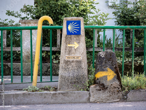 Urban stone monolith located in the city of Monforte de Lemos indicating the kilometer point and the direction to follow for pilgrims on the Camino de Santiago photo