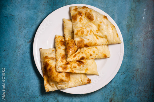 Crispy paratha sliced served in a dish isolated on background top view of pakistani food photo