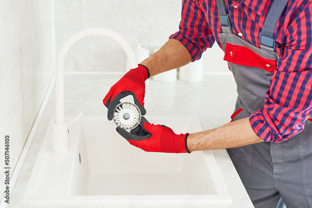 Plumber Installing The Sink, plumbing work or renovation. Plumber hands ...