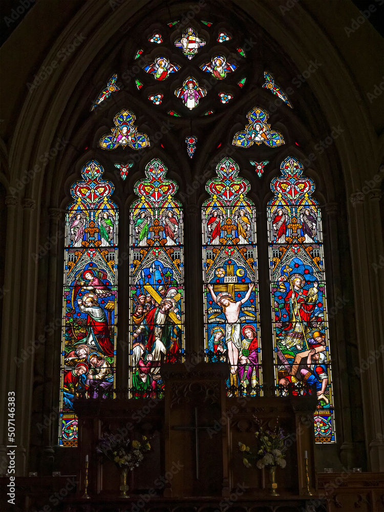 St John the Evangelist Church in Otterburn, Northumberland, UK with stained glass windows.