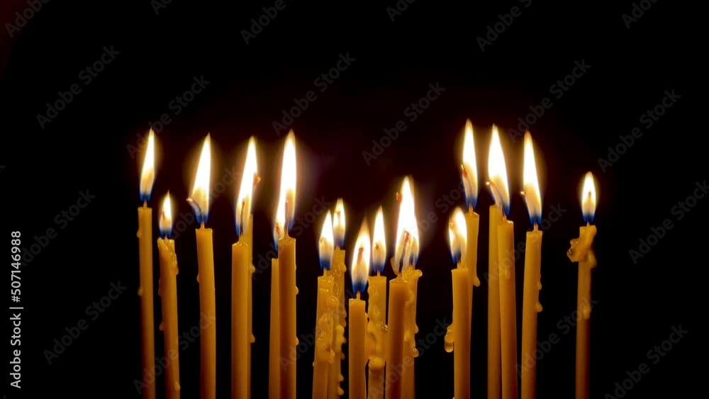 Many wax thin candles burn brightly. Religion concept. High quality 4k footage