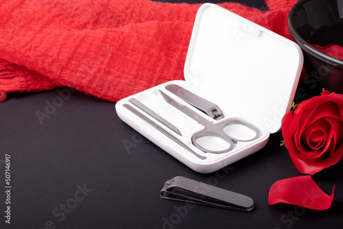 Manicure set in a white case on a dark background with red fabric
