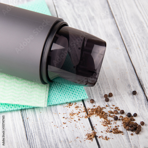 Car vacuum cleaner on a light wood background