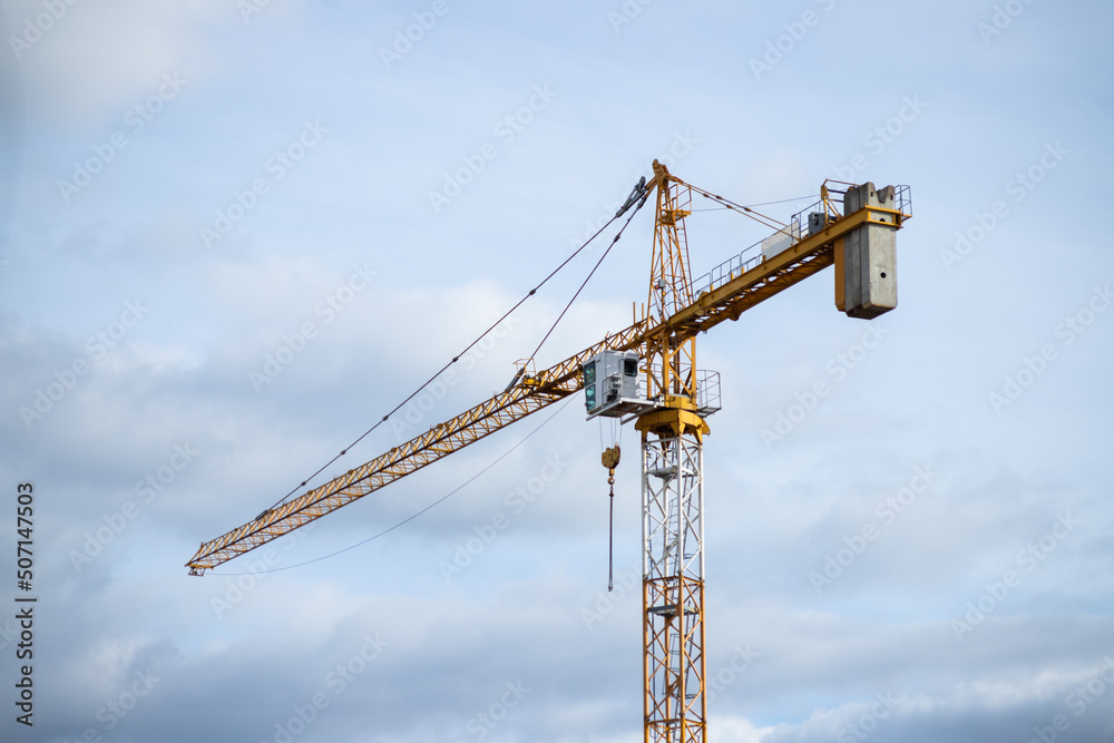 Construction site and yellow crane on the background blue sky Construction site and yellow crane on the background blue sky