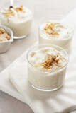 Creamy dairy yoghurt dessert with mascarpone, cream cheese and peanut butter in glasses on marble tray