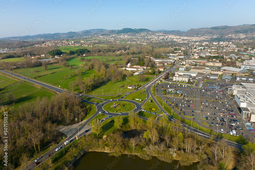 Aerial view of road roundabout intersection with moving heavy traffic. Urban circular transportation crossroads