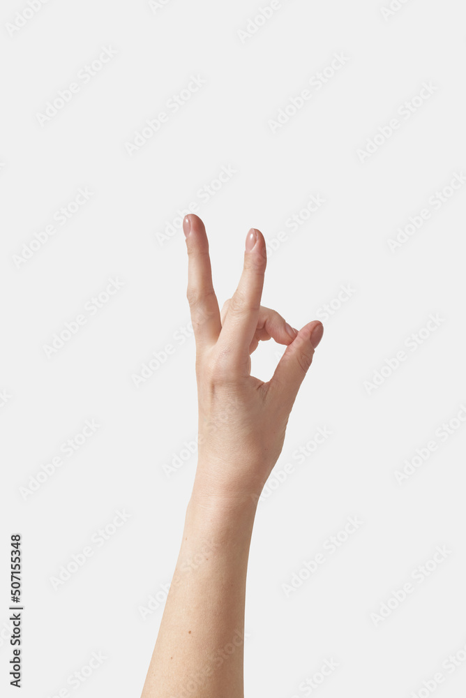 Close up woman hand OK gesture on white. Close up woman hand OK gesture on white.