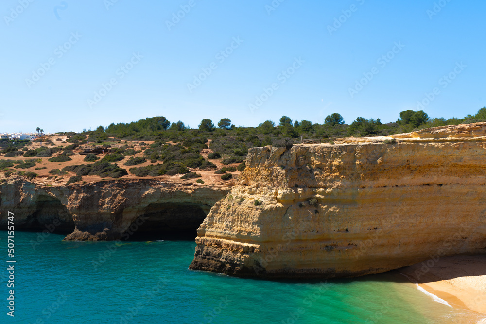 Natural caves on the beach of Marinha, Algarve Portugal. Rocky arches on Marinha beach and turquoise waters off the coast of Portugal in the Algarve region. Natural caves on the beach of Marinha, Algarve Portugal. Rocky arches on Marinha beach and turquoise waters off the coast of Portugal in the Algarve region.