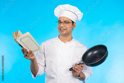 Chef is reading cookbook. M...
