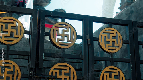 metal fence depicting golden sun shaped like a cross