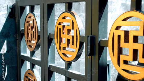 metal fence depicting golden sun shaped like a cross