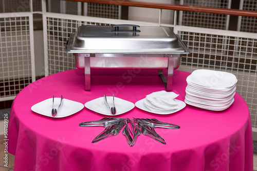 Party table decorated with plates, cutlery and Rechaud photo