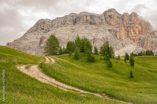 East face of Sasso di Santa Croce mountain range in the eastern Dolomites, its 900 meters vertical wall and Mount Cavallo, seen from Roda de Armentara trail to St. Croce refuge, South Tyrol, Italy
