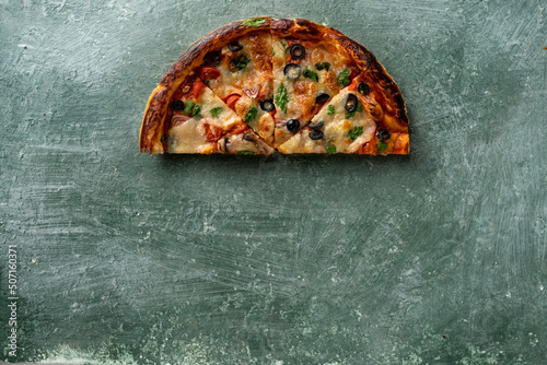 half a delicious homemade italian pizza on the table, pizza with wine, copy space for your text, top view