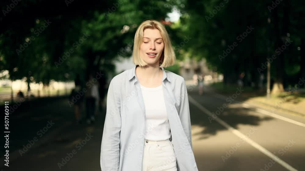 Portrait of attractive smiling woman while walking down the city street. Beautiful woman looking ahead outside. Portrait of attractive smiling woman while walking down the city street. Beautiful woman looking ahead outside.