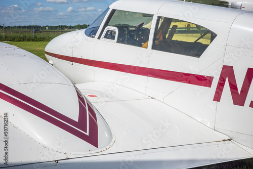 Norwich, Norfolk, UK – May 22 2022. Close up of cockpit windows and along the fuselage of a small airplane © yackers1