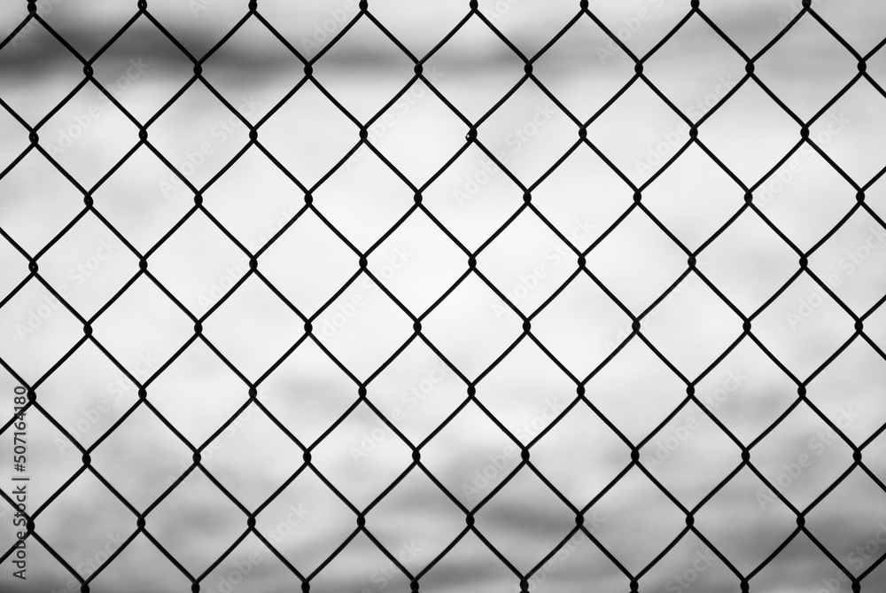 gray background, in the photo a metal mesh on a background of white snow gray background, in the photo a metal mesh on a background of white snow