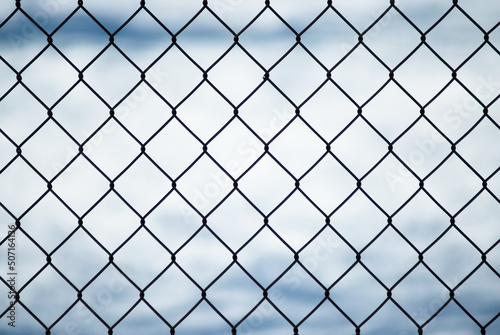 gray background, in the photo a metal mesh on a background of white snow