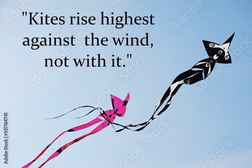 Kites rise highest against the wind, not with it. Motivational and inspirational quote. photo