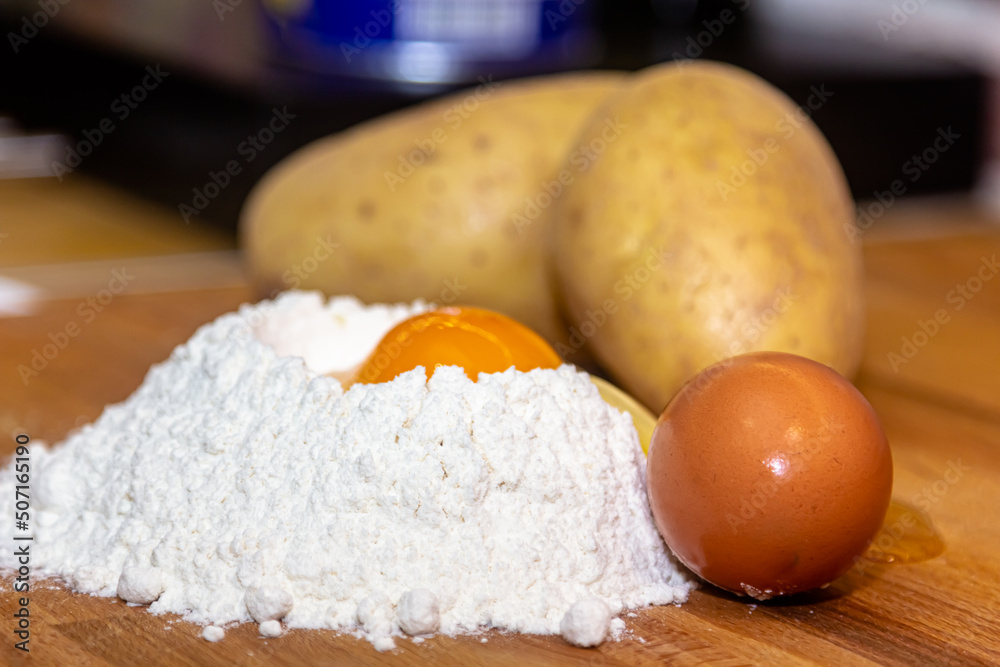 Raw chicken egg and flour on white background,homemade food, homemade pasta Raw chicken egg and flour on white background,homemade food, homemade pasta