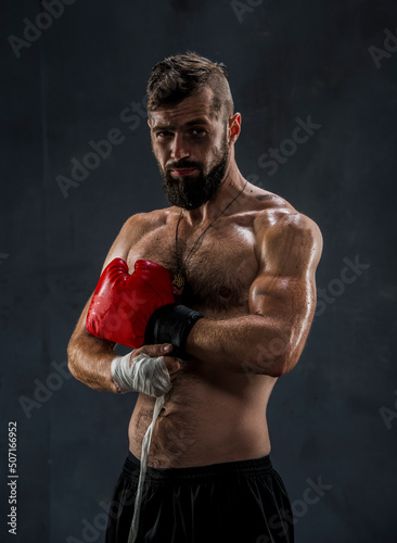 boxer getting ready for a fight wrapping tape around his hands © serhii