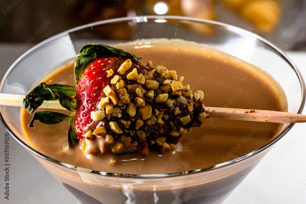 Chocolate drink with whipped cream, strawberry and pieces of black chocolate on a dark background. Chocolate drink with whipped cream, strawberry and pieces of black chocolate on a dark background.