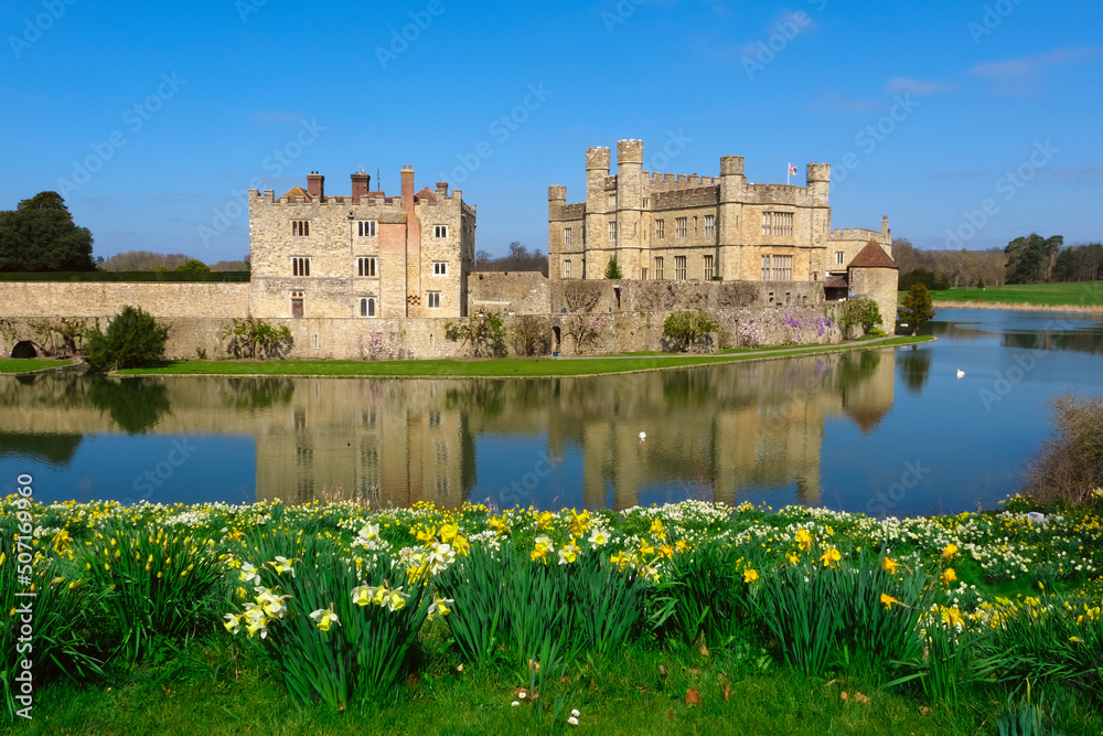 View of Leeds Castle in Kent, UK. Leeds Castle, England, reflection, spring sunny day, with flowers blooming.