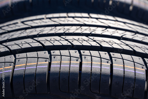 new car summer tires in a row. Car tire tread close-up. photo