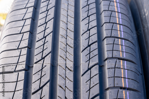new car summer tires in a row. Car tire tread close-up. photo