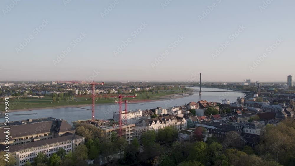 Aerial cityscape of German big city. Riverfront of Dusseldorf with bridge, commercial and historic buildings Aerial cityscape of German big city. Riverfront of Dusseldorf with bridge, commercial and historic buildings