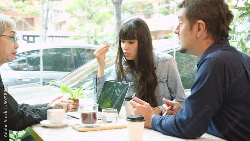 Senior woman talking about agreement of project and explaining with businesspeople in the cafe, elderly conversation and deal with partnership about business in the coffee shop, adviser and agent.