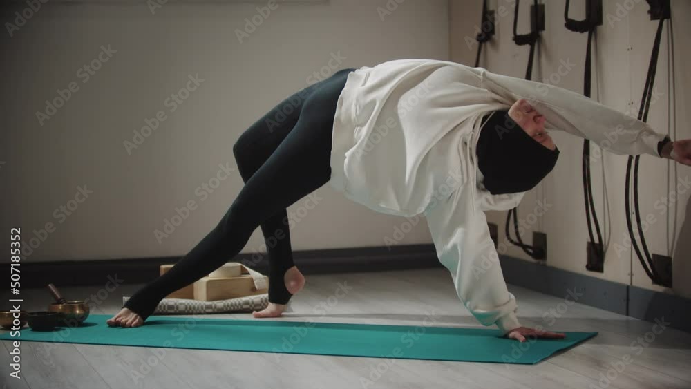 Yoga - young woman in hijab doing stretching exercises on yoga mat Yoga - young woman in hijab doing stretching exercises on yoga mat