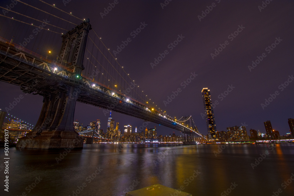 Brooklyn Bridge at dusk viewed from the Brooklyn Bridge Park in New York City.
