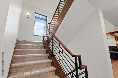 Double staircase in home with carpet protection