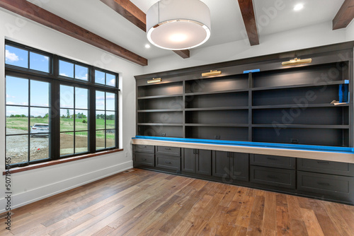 Empty office with black windows and custom built ins