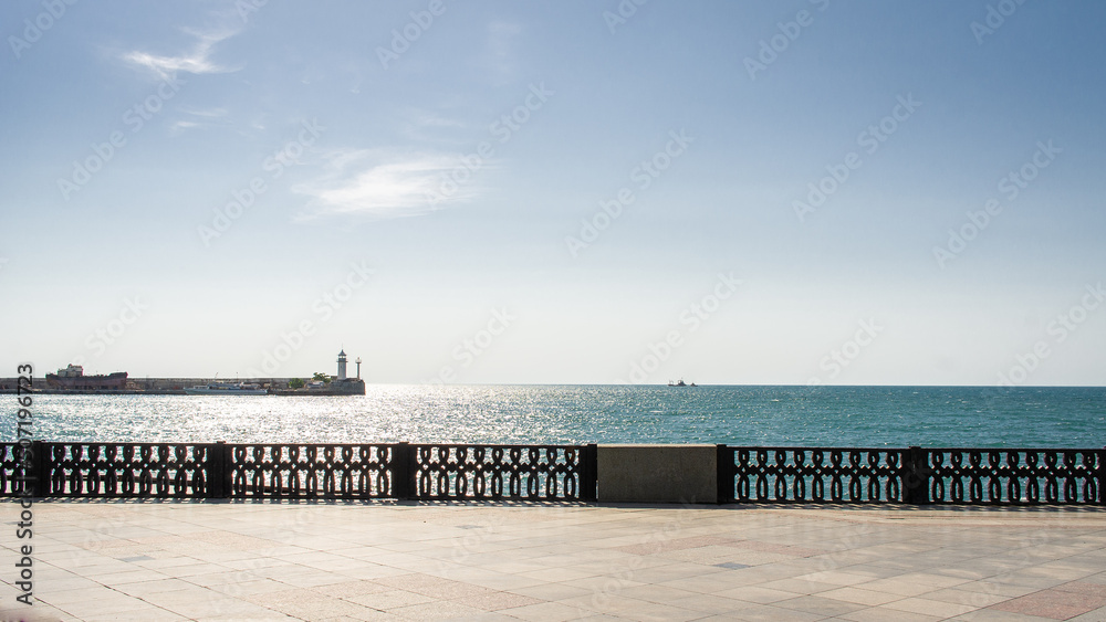 The embankment of the city of Yalta. The lighthouse and the sea. Front view.