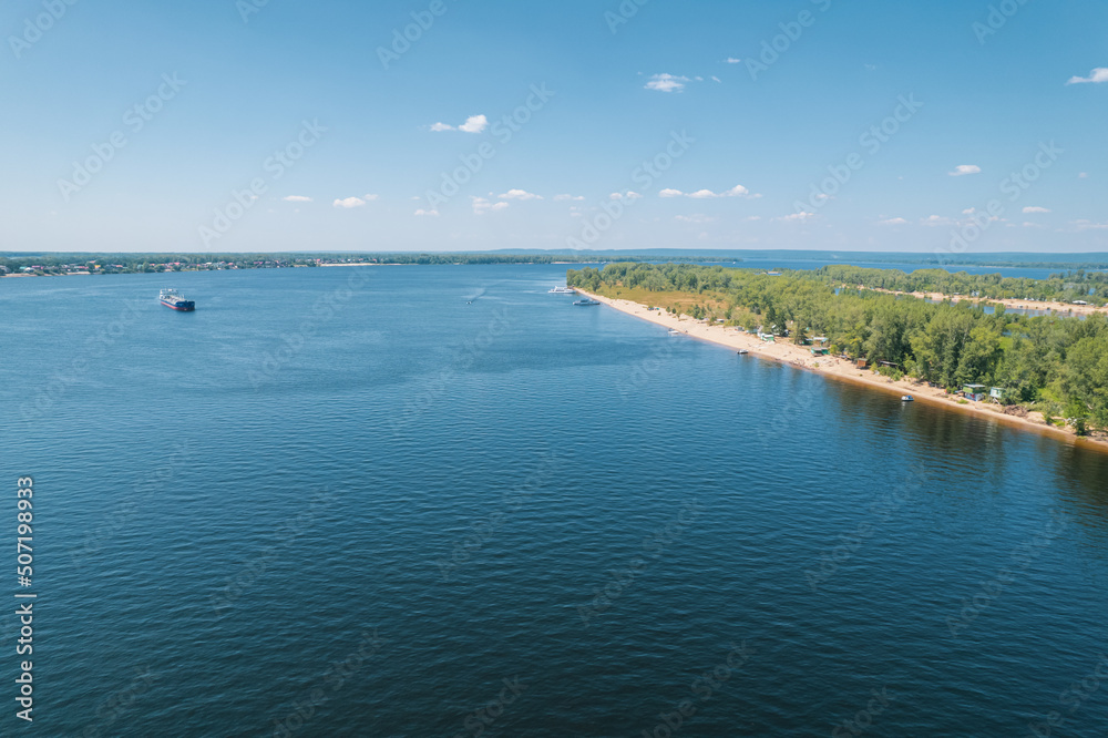Aerial landscape view on Volga river with islands and green forest. Picturesque panoramic view from the height on the touristic part of the Volga river near Samara city at summer sunny day. Aerial landscape view on Volga river with islands and green forest. Picturesque panoramic view from the height on the touristic part of the Volga river near Samara city at summer sunny day.