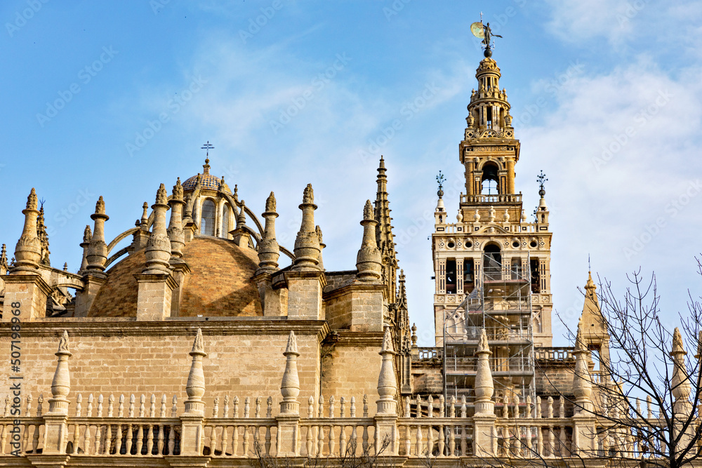 Seville cathedral Giralda tower of Sevilla Andalusia Spain Church on sunny day.
