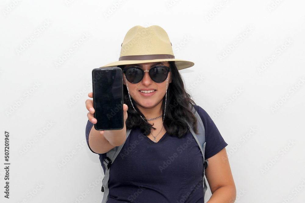 Young latin woman with backpack, sunglasses and hat walks down the street like a tourist with a cell phone in her hand looking for information and taking photos
Young latin woman with backpack, sunglasses and hat walks down the street like a tourist with a cell phone in her hand looking for information and taking photos