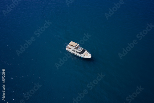 Yacht on blue water. Aerial view luxury motor boat. Top view of the boat. © Berg