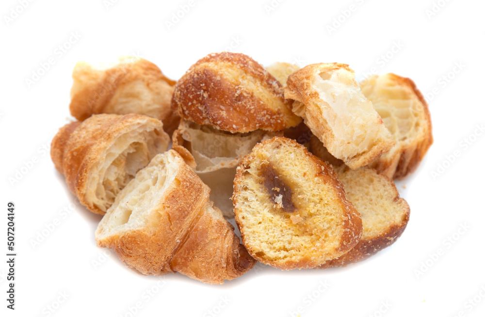 Pieces of dry croissant on a white background.