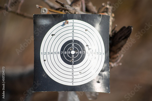 Shot through a paper target for a shooting range.