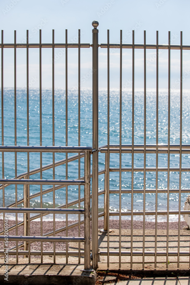 galvanized fence on the background of the sea galvanized fence on the background of the sea