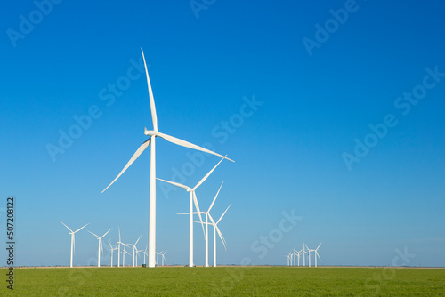 Wind Turbine Farm in Texas with Blue Sky and Green Field